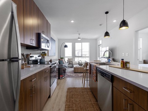 A modern kitchen with wooden cabinets and stainless steel appliances.