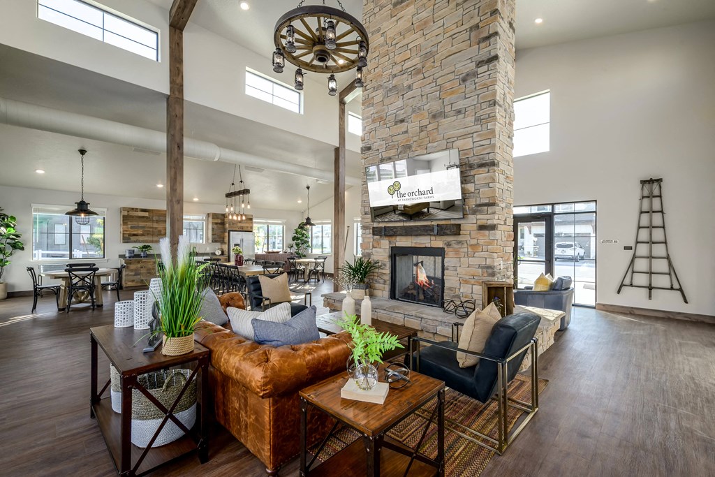 the gathering room has a large stone fireplace in the center of the room