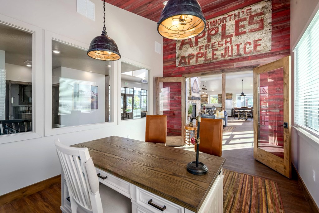 a dining room with a wooden table and chairs in front of a window
