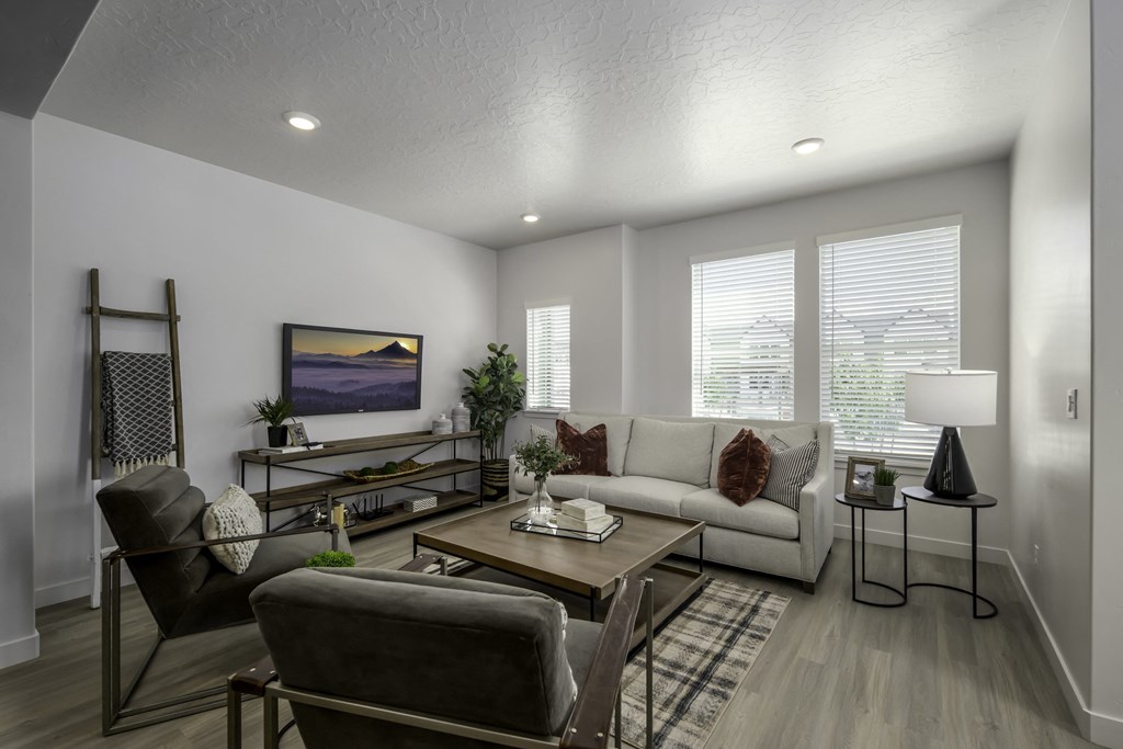 a living room with a couch and chairs and a table