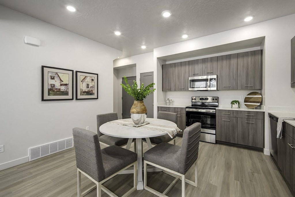 a kitchen and dining room with a table and chairs