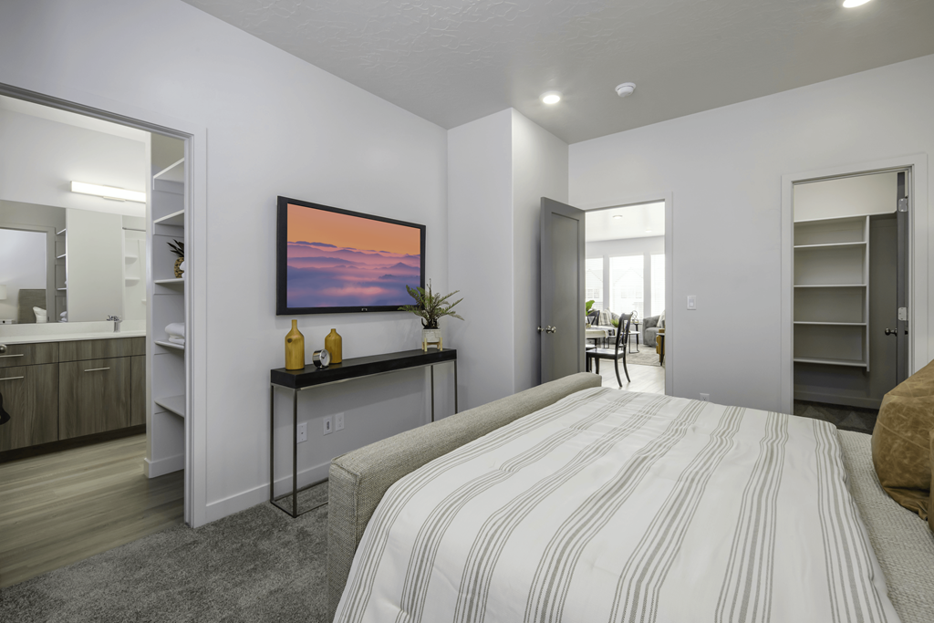 a bedroom with a bed and a bathroom in a house