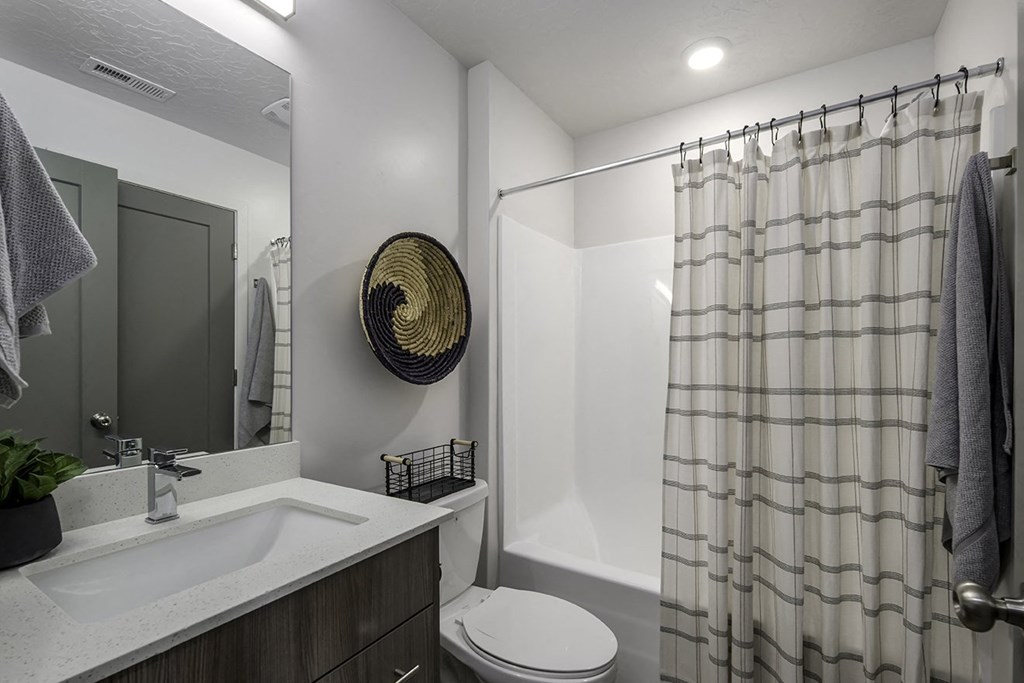 a bathroom with a shower and a sink and a toilet