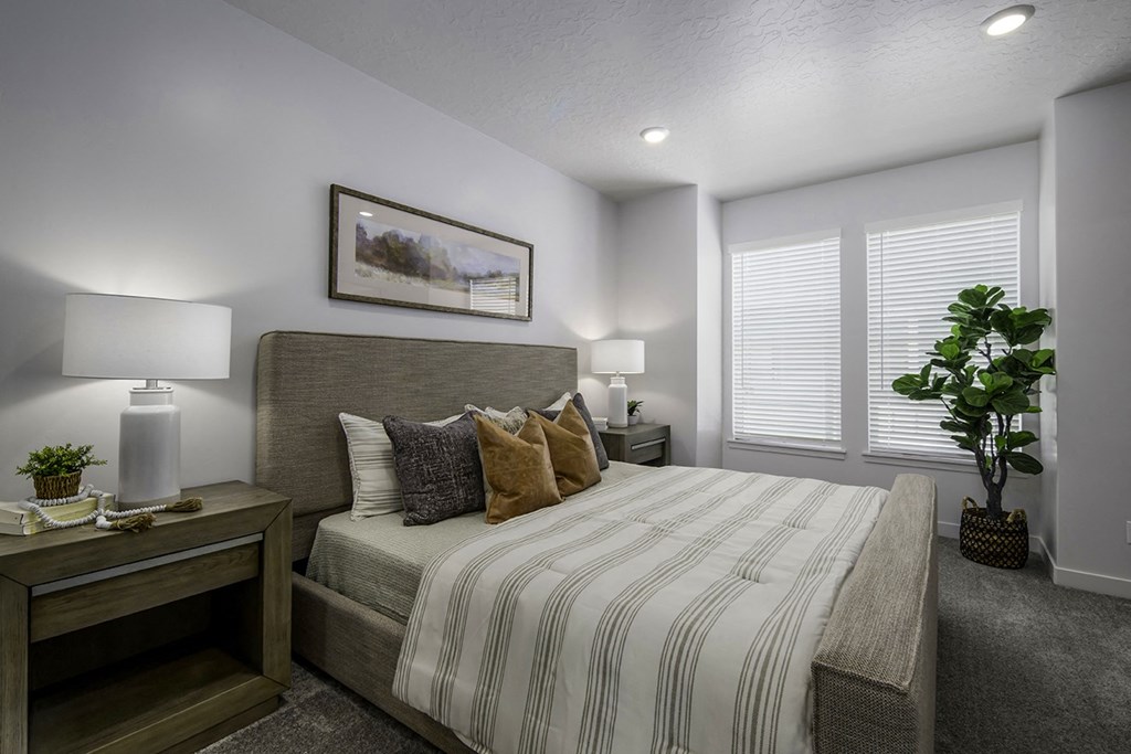 a bedroom with a large bed and a window