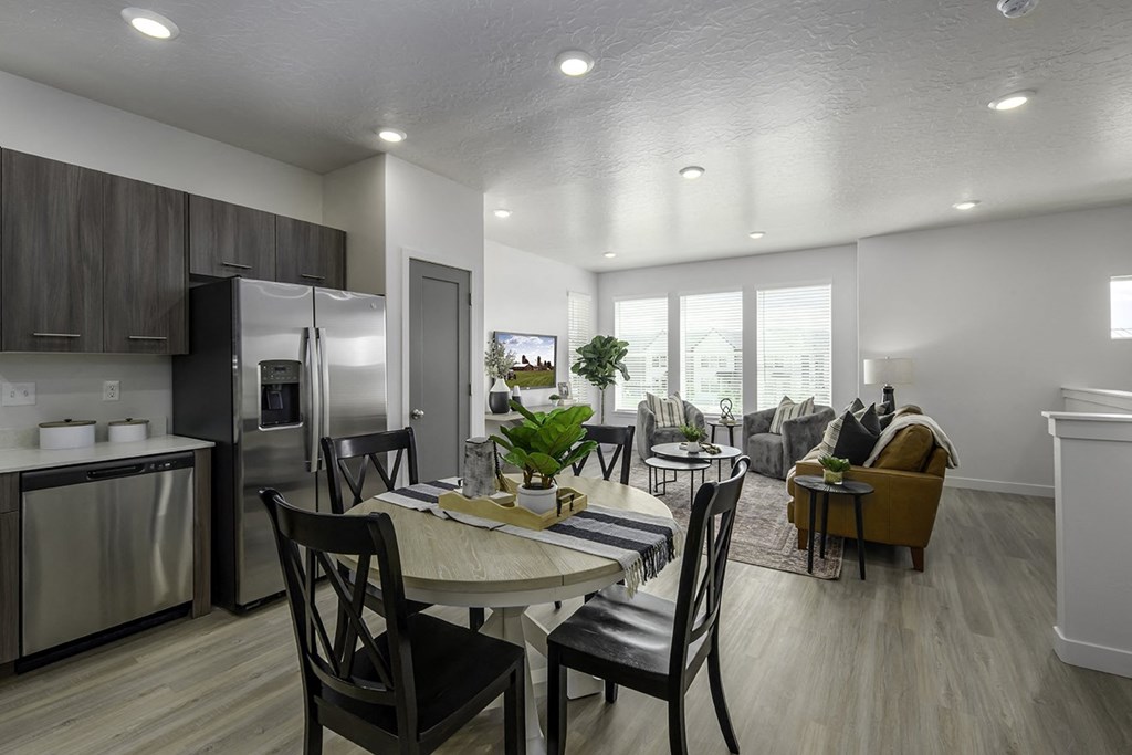 an open kitchen and living room with a dining table