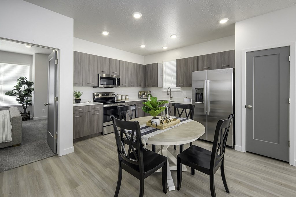 an open kitchen and dining room with a table and chairs