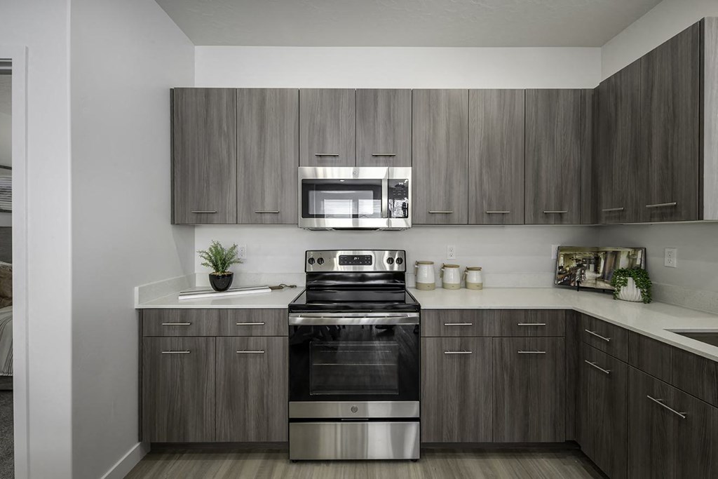 a kitchen with stainless steel appliances and wooden cabinets