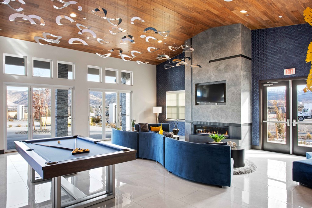 a game room with a pool table and a flat screen tv