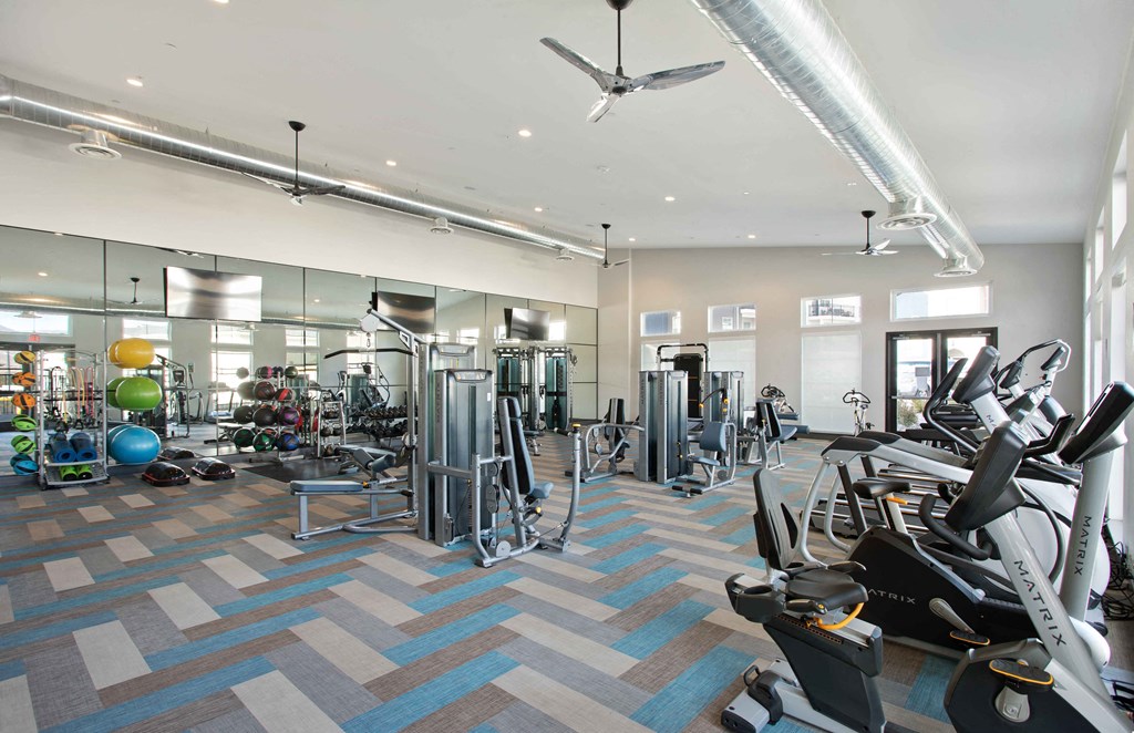 a gym with treadmills and other exercise equipment