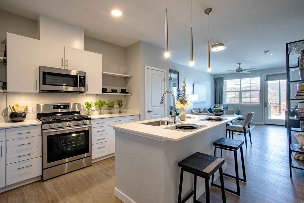 a kitchen with an island and a stove and a microwave