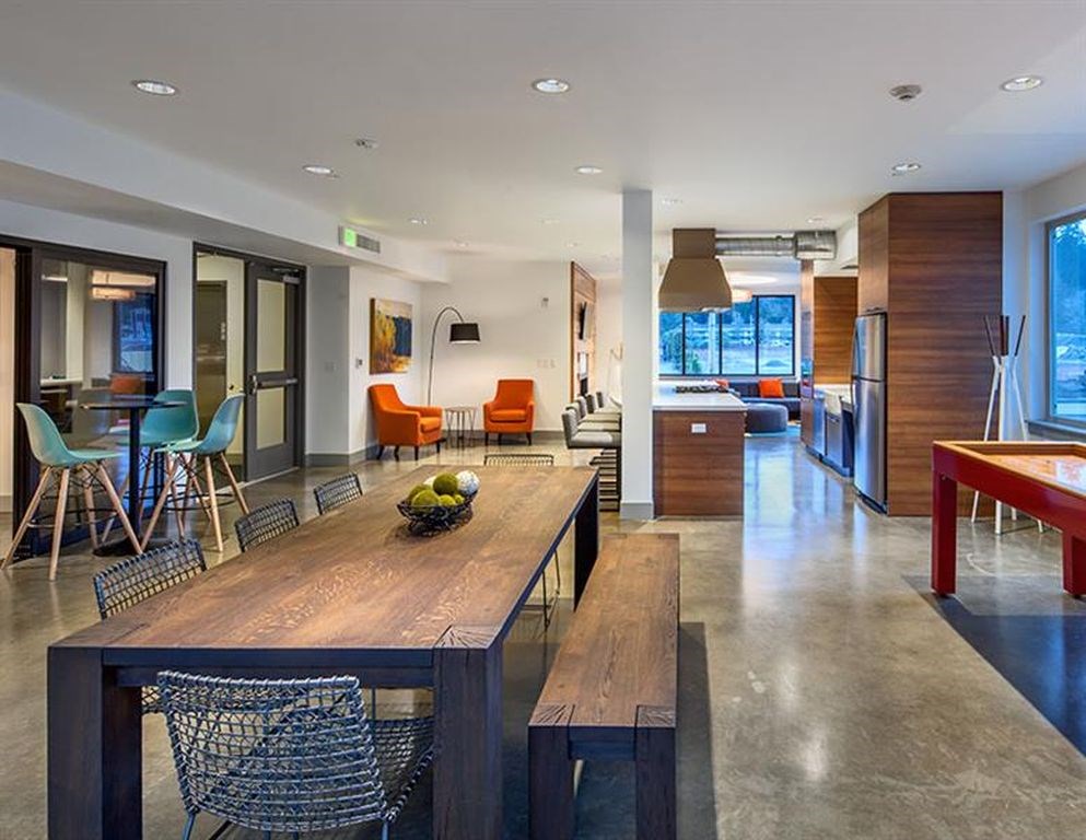 A modern dining room with a wooden table and chairs.
