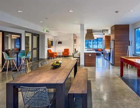 A modern dining room with a wooden table and chairs.