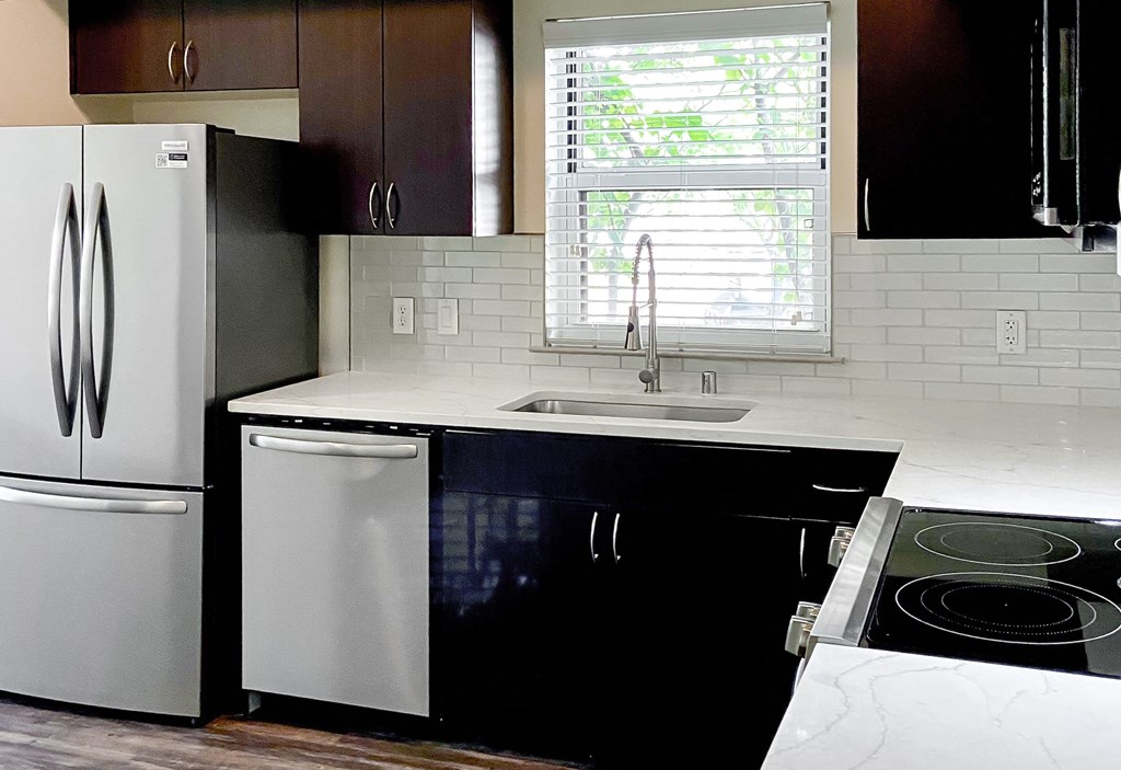 a kitchen with a sink and a refrigerator