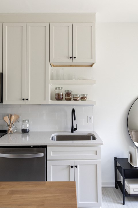 A kitchen with a sink and a dishwasher.