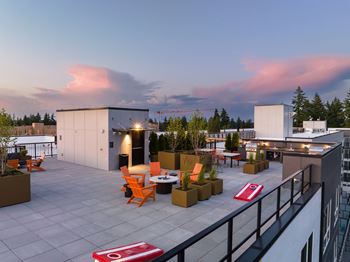 a roof top terrace with orange chairs and potted plants at Ion Town Center, Shoreline, 98133