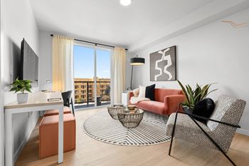 a living room with white walls and a sliding glass door that leads to a balconyat Ion Town Center, Washington