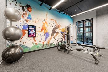 a mural of children on a climbing wall in a gym at Ion Town Center, Shoreline, WA