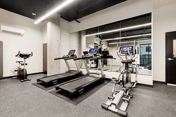 a gym with treadmills and elliptical machines at Ion Town Center, Shoreline, WA 98133