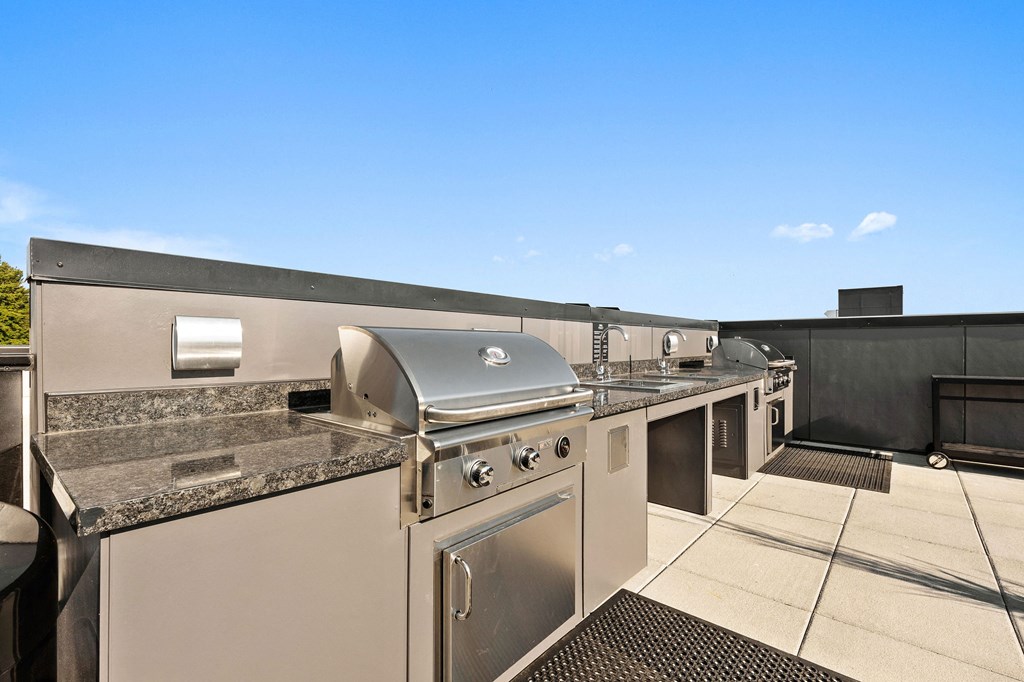 a kitchen with stainless steel appliances and granite counter tops at Ion Town Center, Shoreline, WA