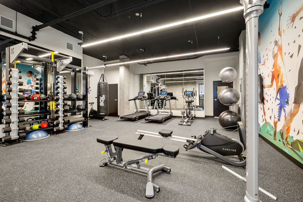 a large fitness room with weights and other exercise equipment at Ion Town Center, Washington