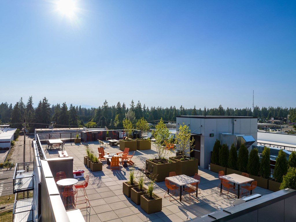 a view of the roof terrace with tables and chairs and potted plants at Ion Town Center, Shoreline, WA