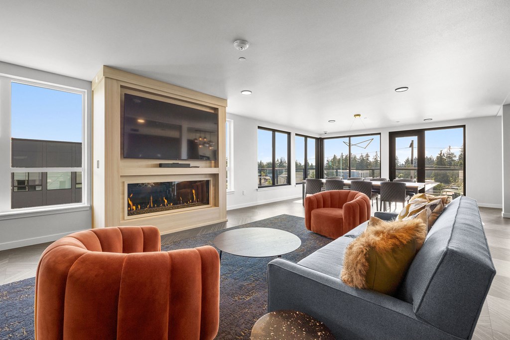a living room with a fireplace and large windows at Ion Town Center, Shoreline, WA