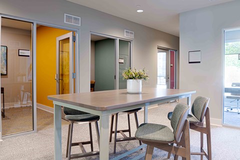 A dining room with a table and chairs.