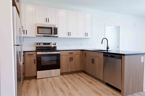 A kitchen with wooden cabinets and stainless steel appliances.