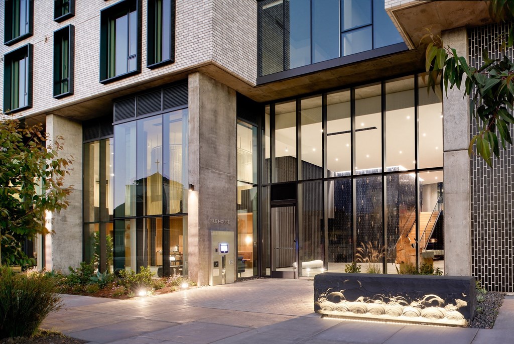 an office building with large glass windows and a courtyard