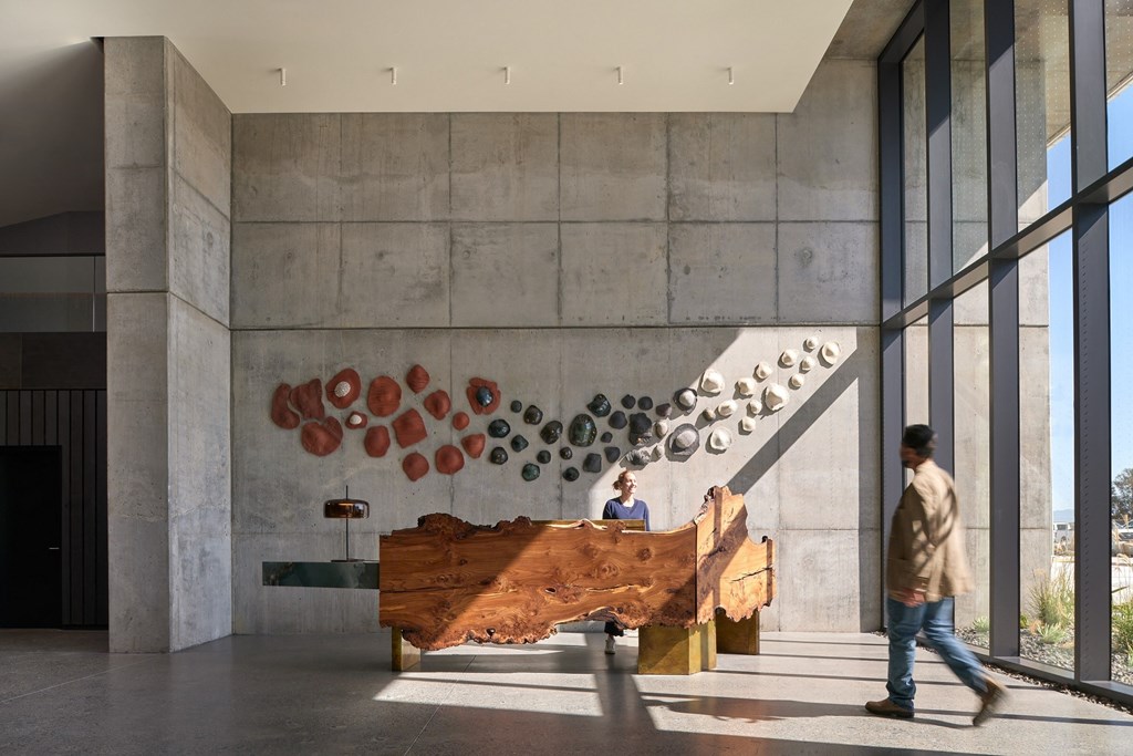 a large wooden piano sits in the lobby of a building