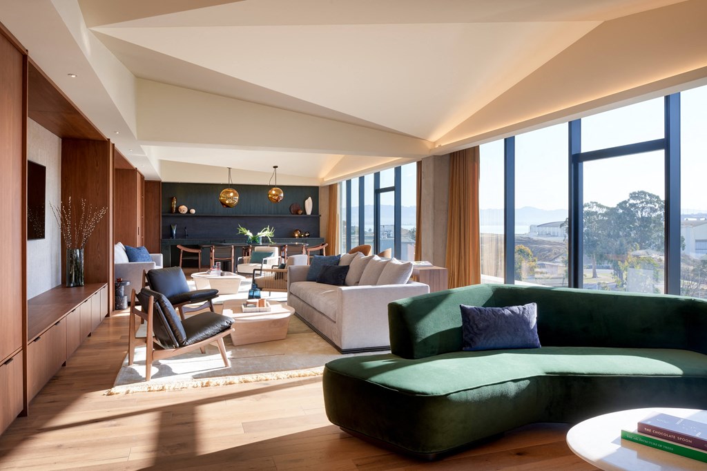 a living room with a green couch and a table