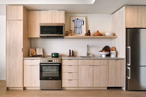 a kitchen with wooden cabinets and stainless steel appliances