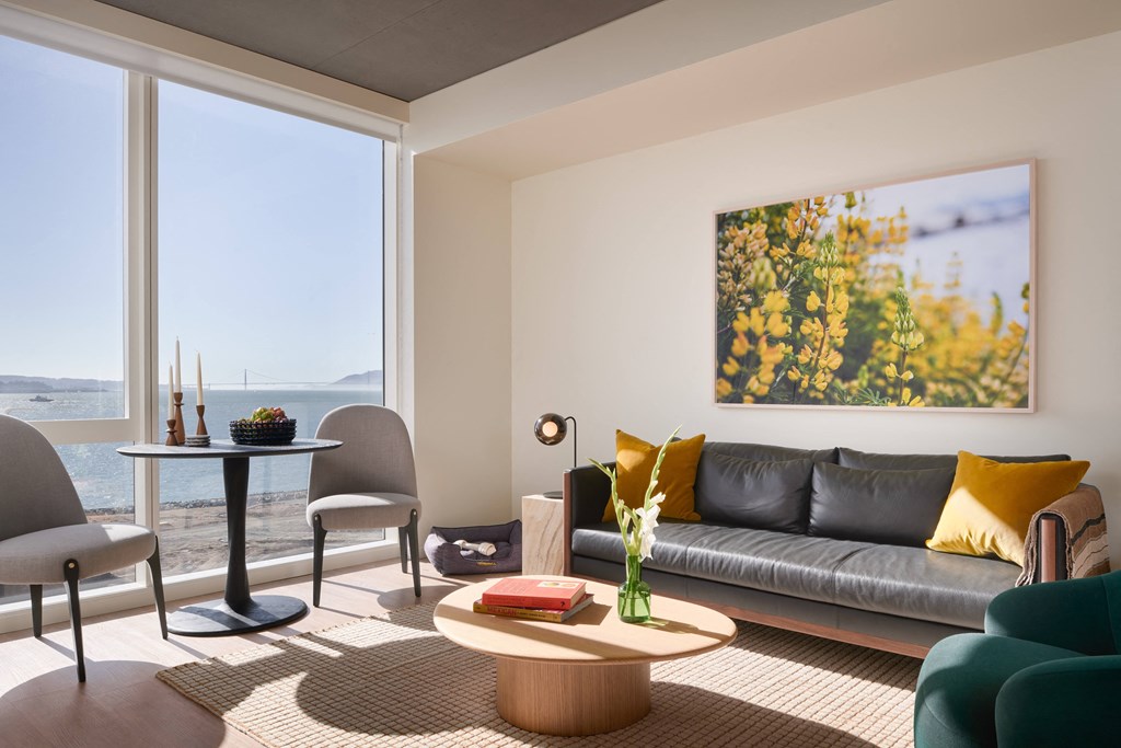 a living room with a couch and a table and a large window