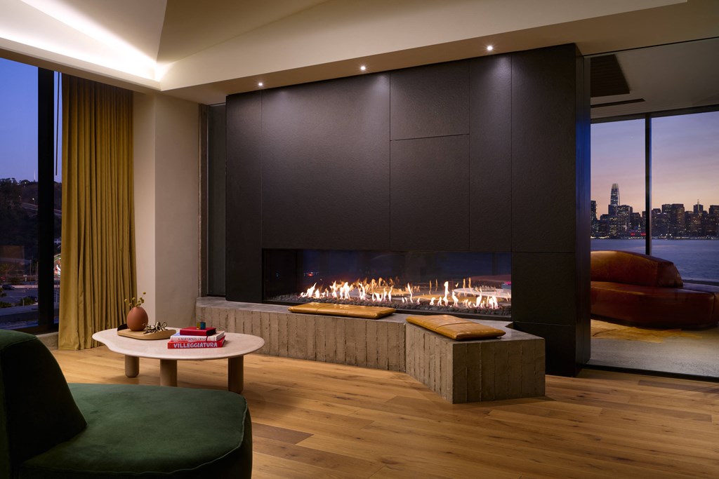 a living room with a fireplace and a view of the city