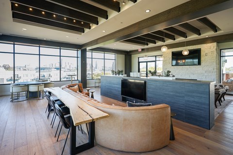 A modern office space with a long wooden table and chairs.