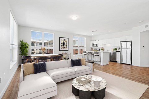 A modern living room with a white sofa and a coffee table.