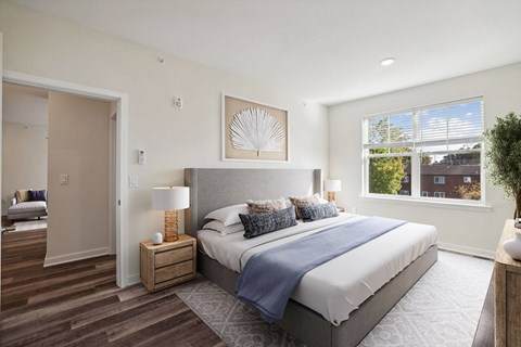 a bedroom with a bed and a window