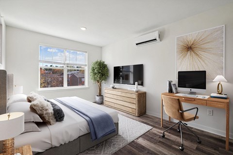 a bedroom with a bed and a desk with a television