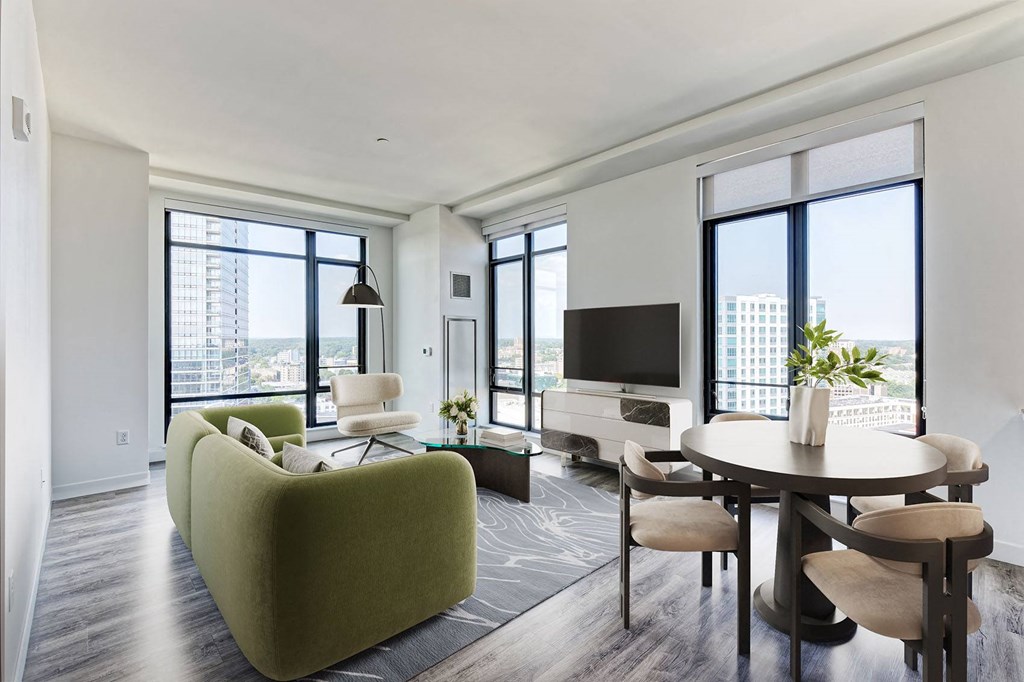 a living room filled with furniture and a large window
