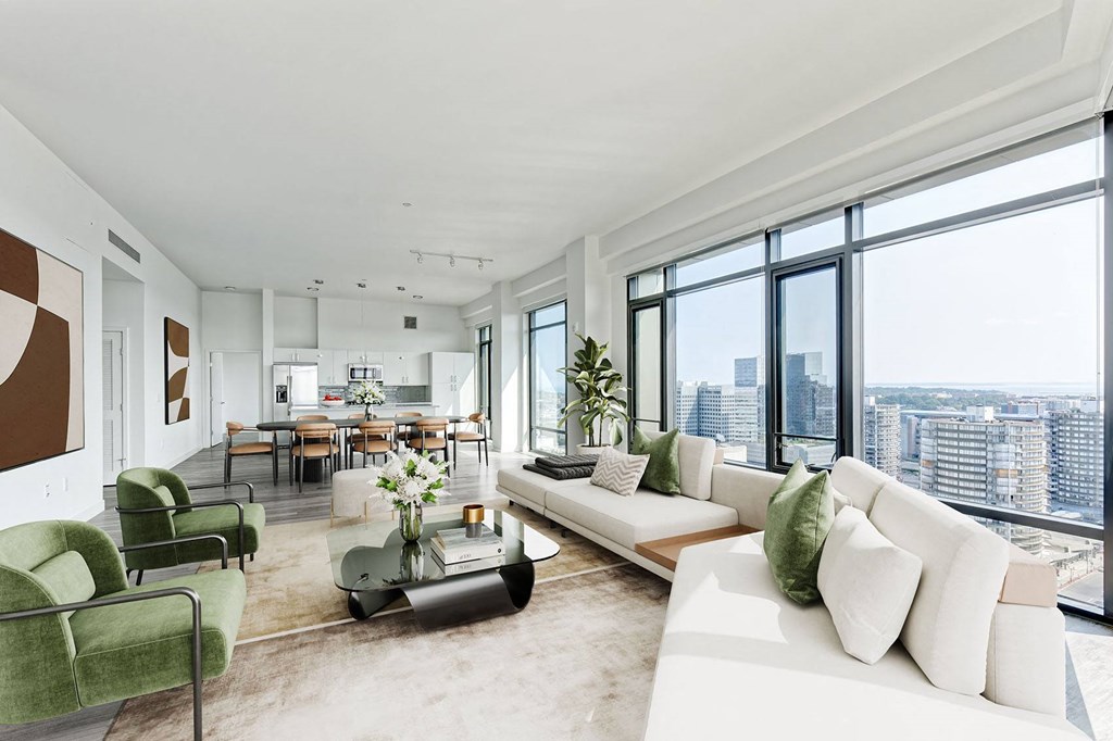 a living room with a white couch and a table with a vase of flowers on it