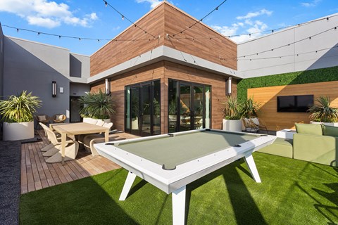 a backyard with a pool table and a tv