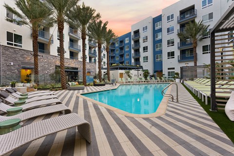 a swimming pool in front of an apartment building
