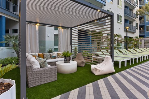 a patio with white furniture and a white table