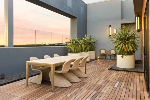 a dining area with a table and chairs on a balcony