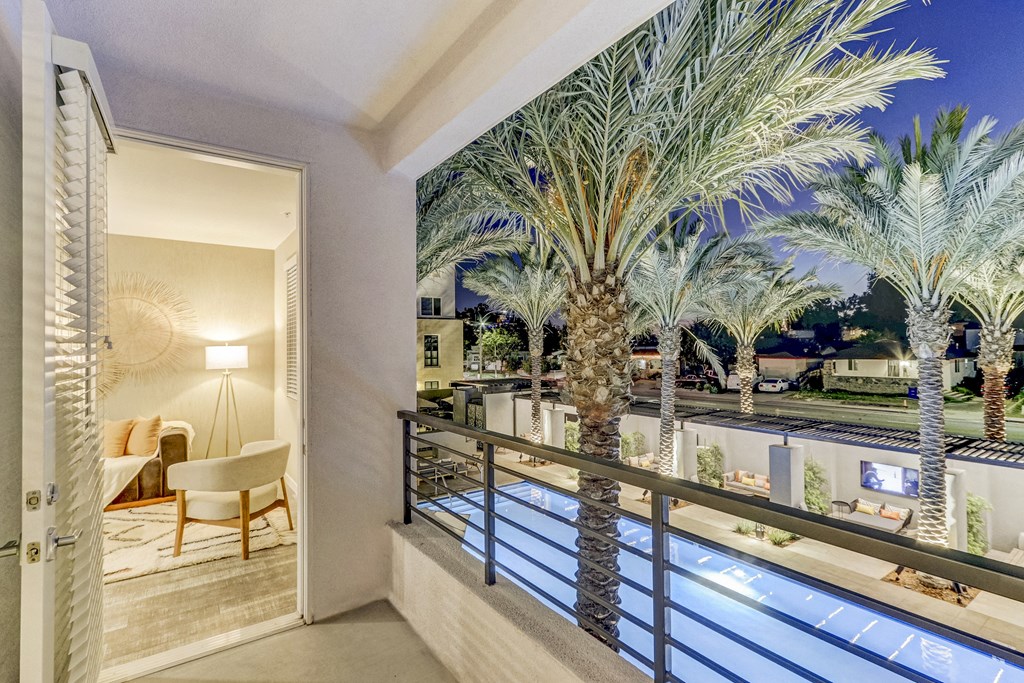Balcony with a pool and palm trees at Array La Mesa, La Mesa California