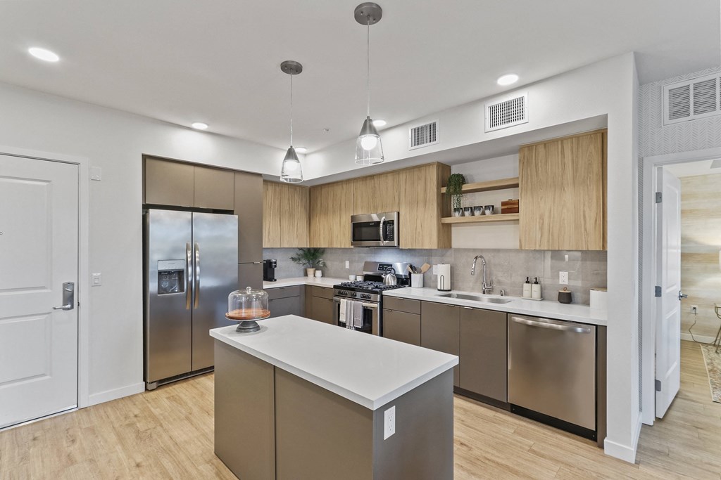 Kitchen with wood floors and stainless steel appliances at Array La Mesa, La Mesa