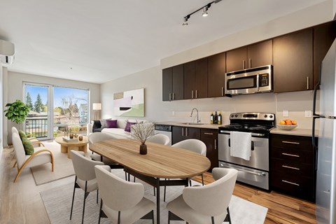 a kitchen and living room with a table and chairs