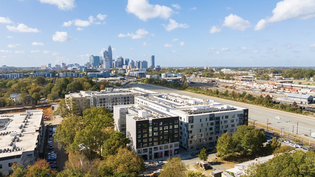 A cityscape with a clear blue sky and a distant skyline.