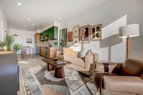A living room with a brown couch and a rug.