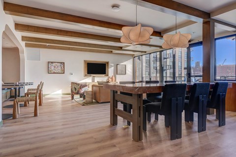 A modern dining room with a wooden table and chairs.